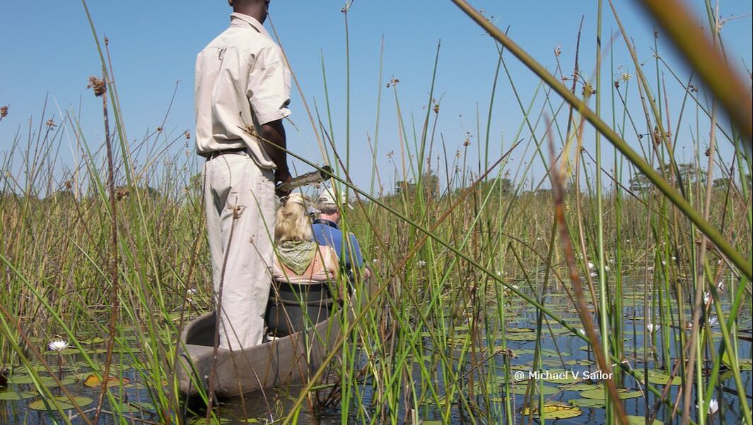 Couple in mokoro canoe Okavango Delta, Botswana