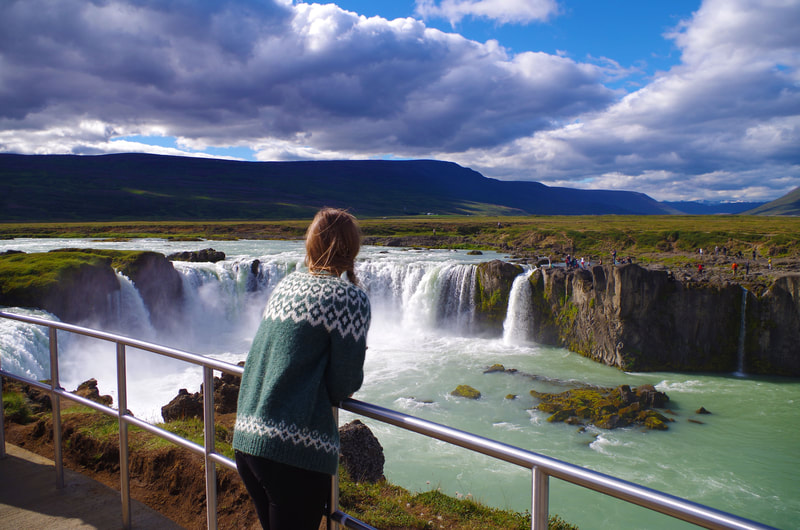 Girl looking at waterfall on Golden Circle in Iceland