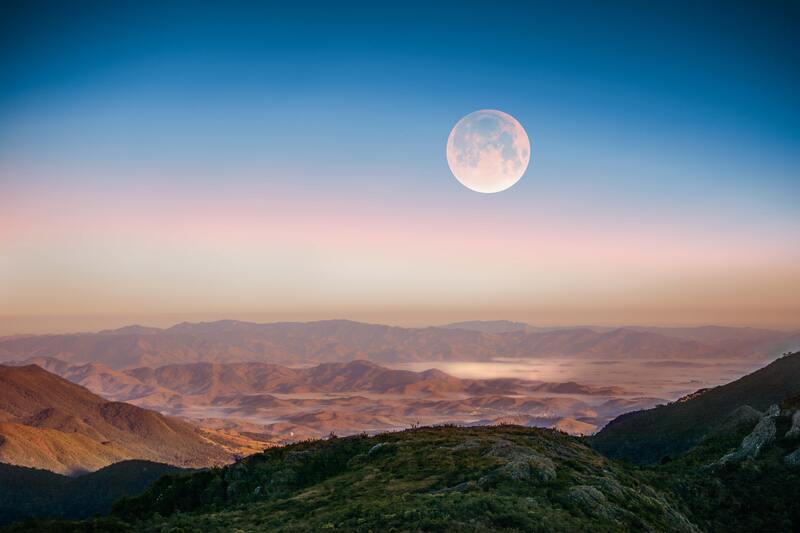 view of moon overlooking mountains